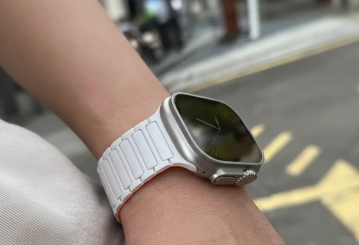 Smartwatch with a white band on a wrist, blurred background