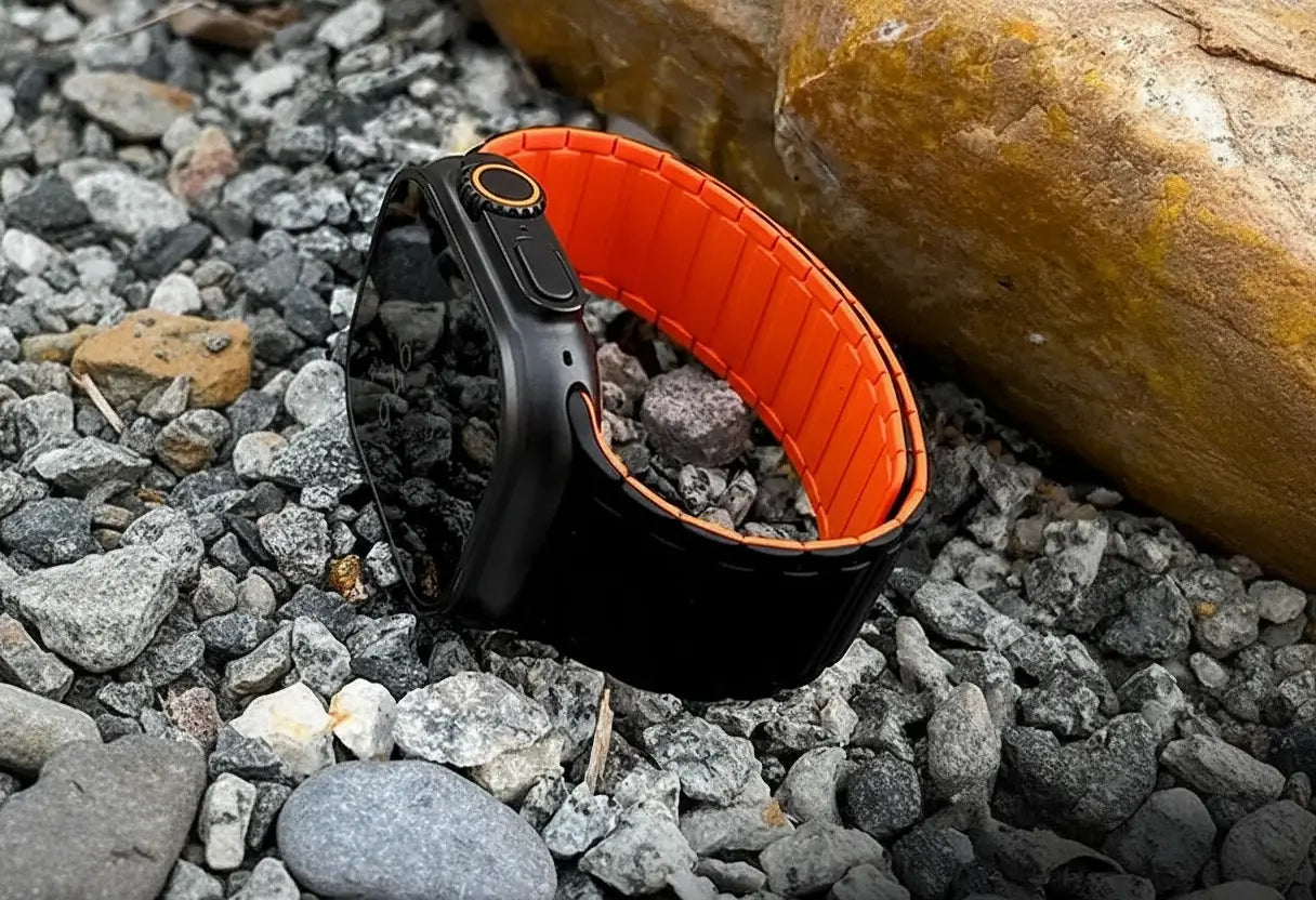 Black and orange dog collar on a rocky surface