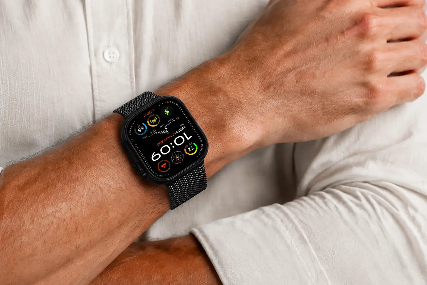 Person adjusting a black smartwatch on their wrist against a neutral background