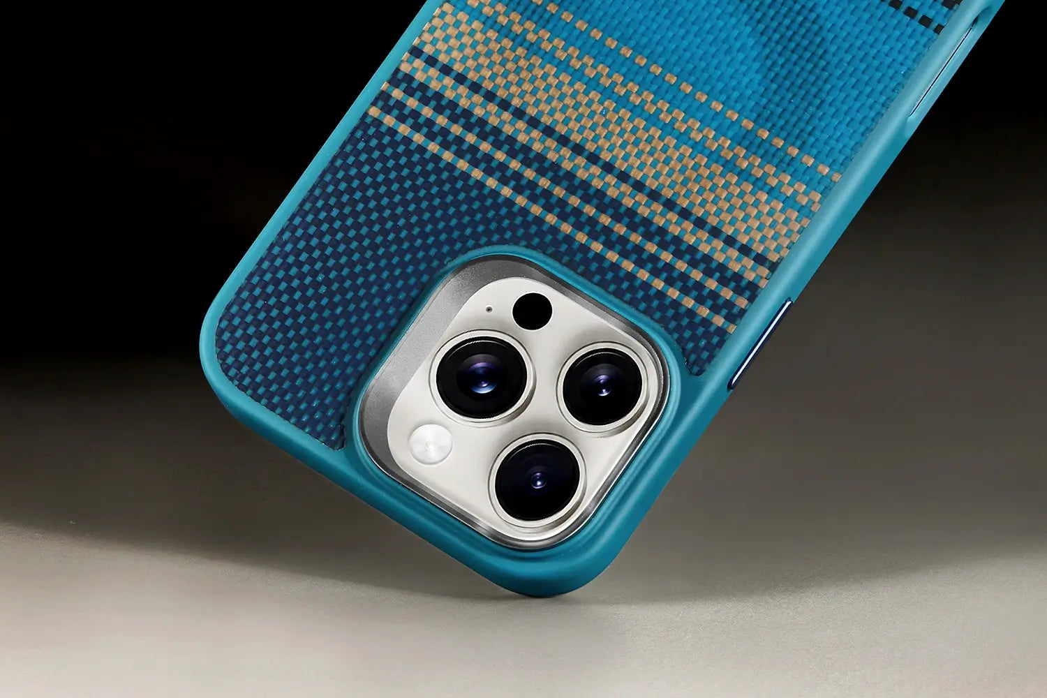 Blue phone case with textured pattern on a dark background