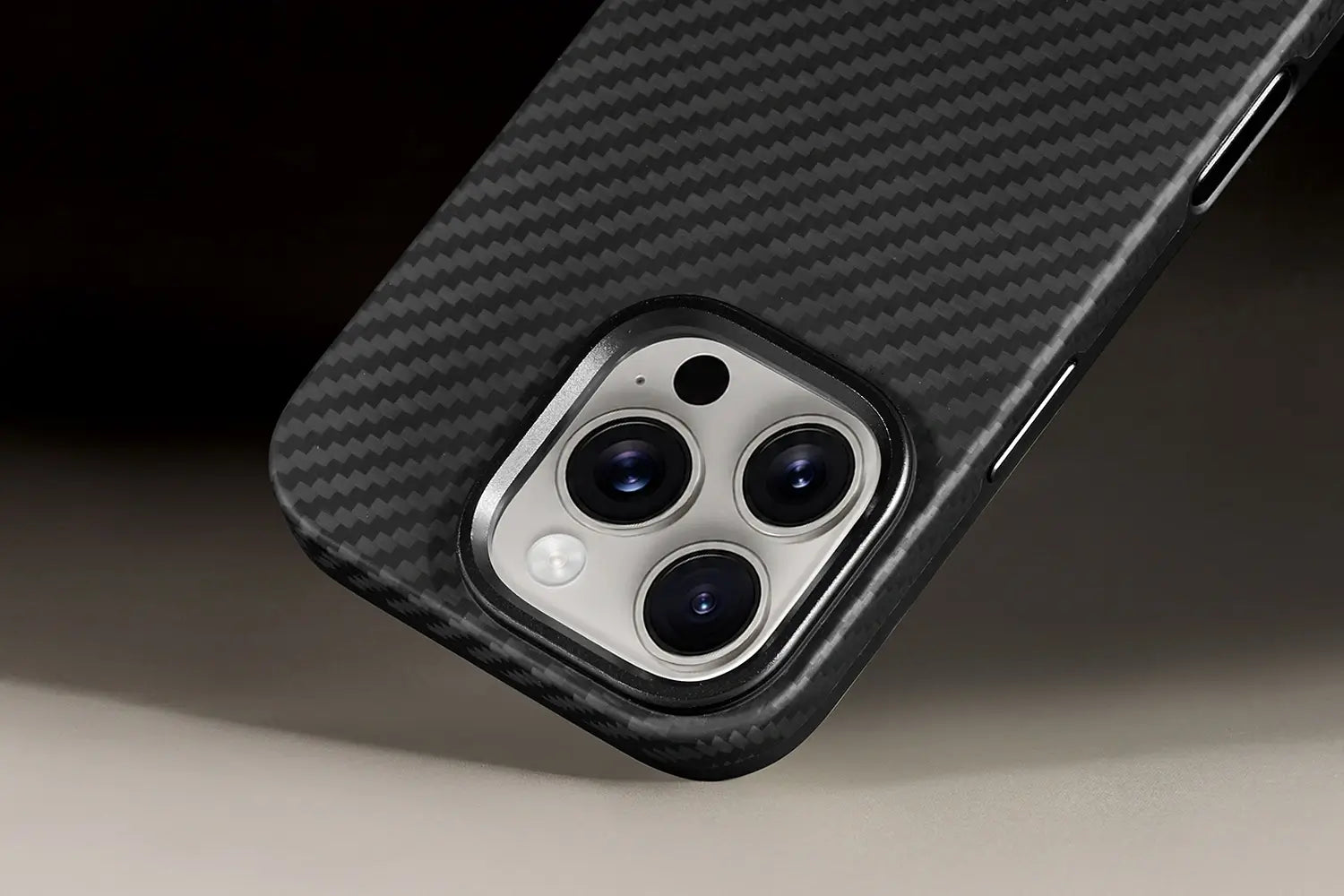 Close-up of a phone case with carbon fiber texture on a neutral background