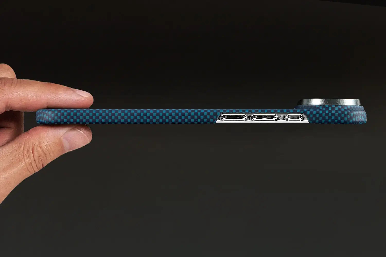 Blue phone case with carbon fiber texture held by a hand on a black background