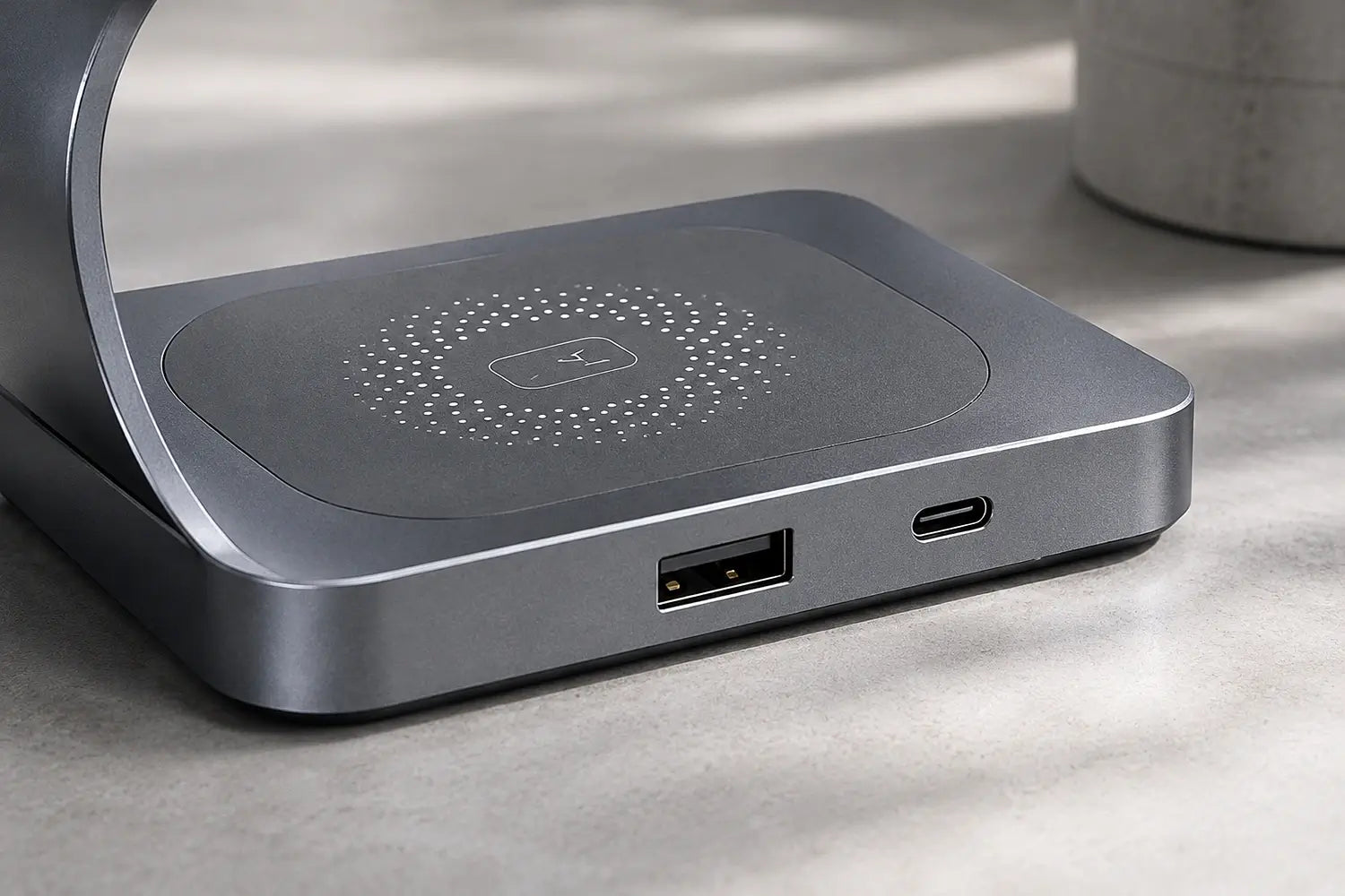 Gray electronic device with USB and charging ports on a light surface