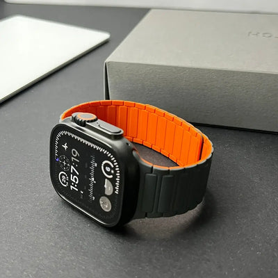 Smartwatch with an orange band on a gray surface