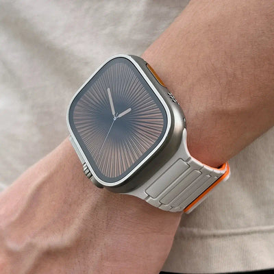 Smartwatch with a gray strap on a wrist against a neutral background