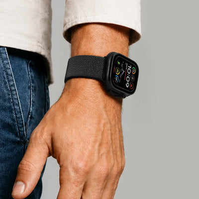 Person wearing a black smartwatch on a plain background