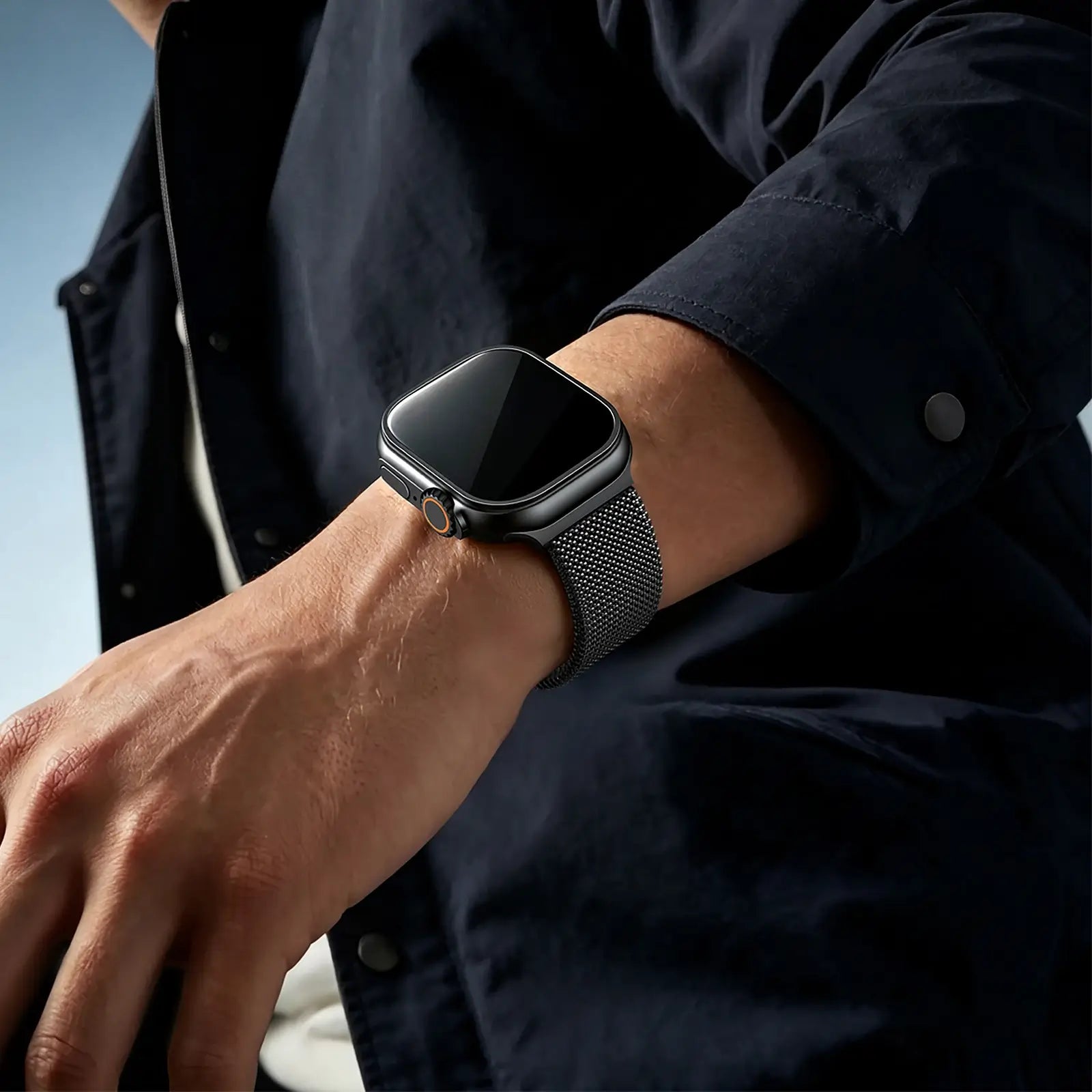 Person wearing a black smartwatch on a blurred background